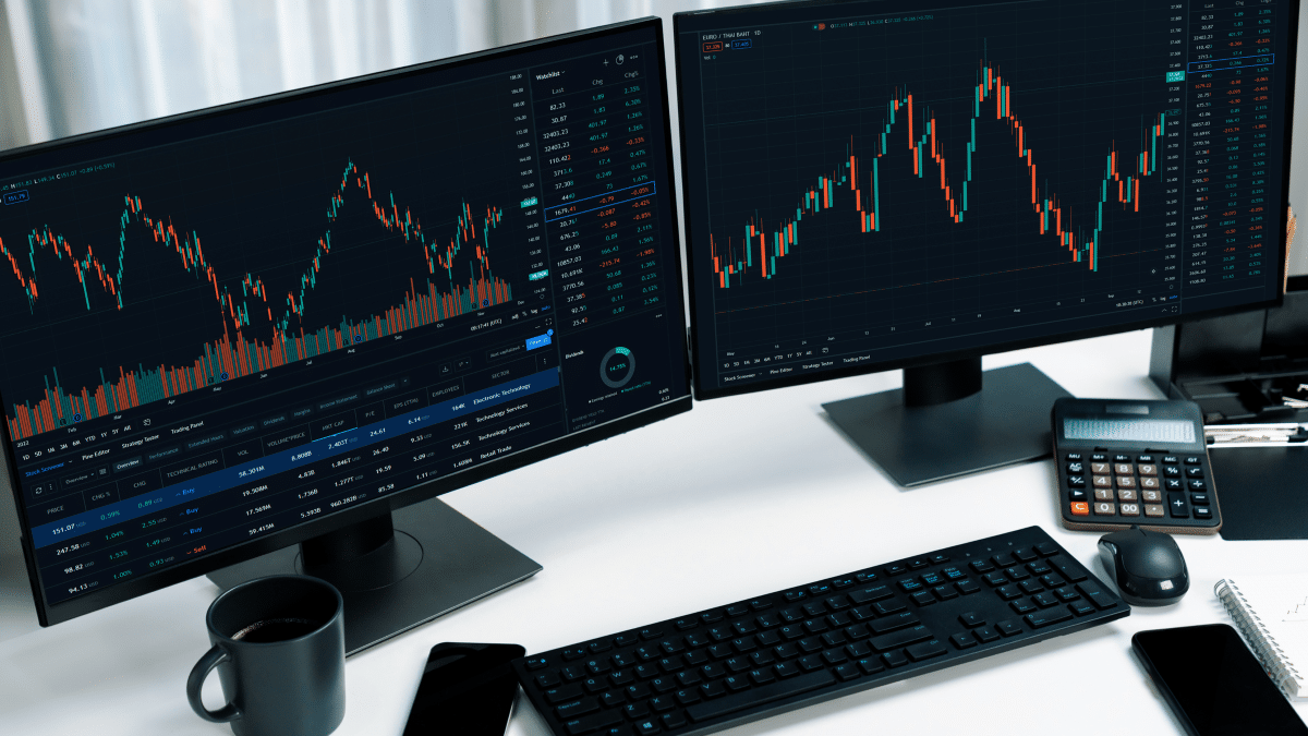 Dual-monitor trading desk showing SPX and SPY 0DTE candlestick charts